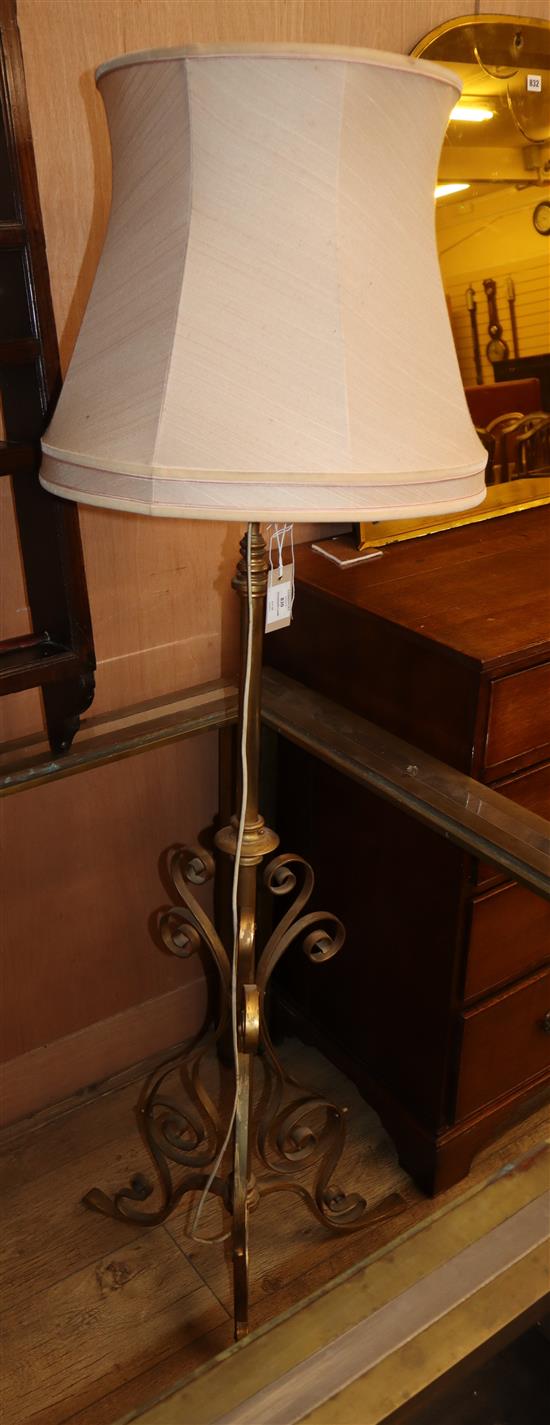An Edwardian wrought iron brass standard lamp